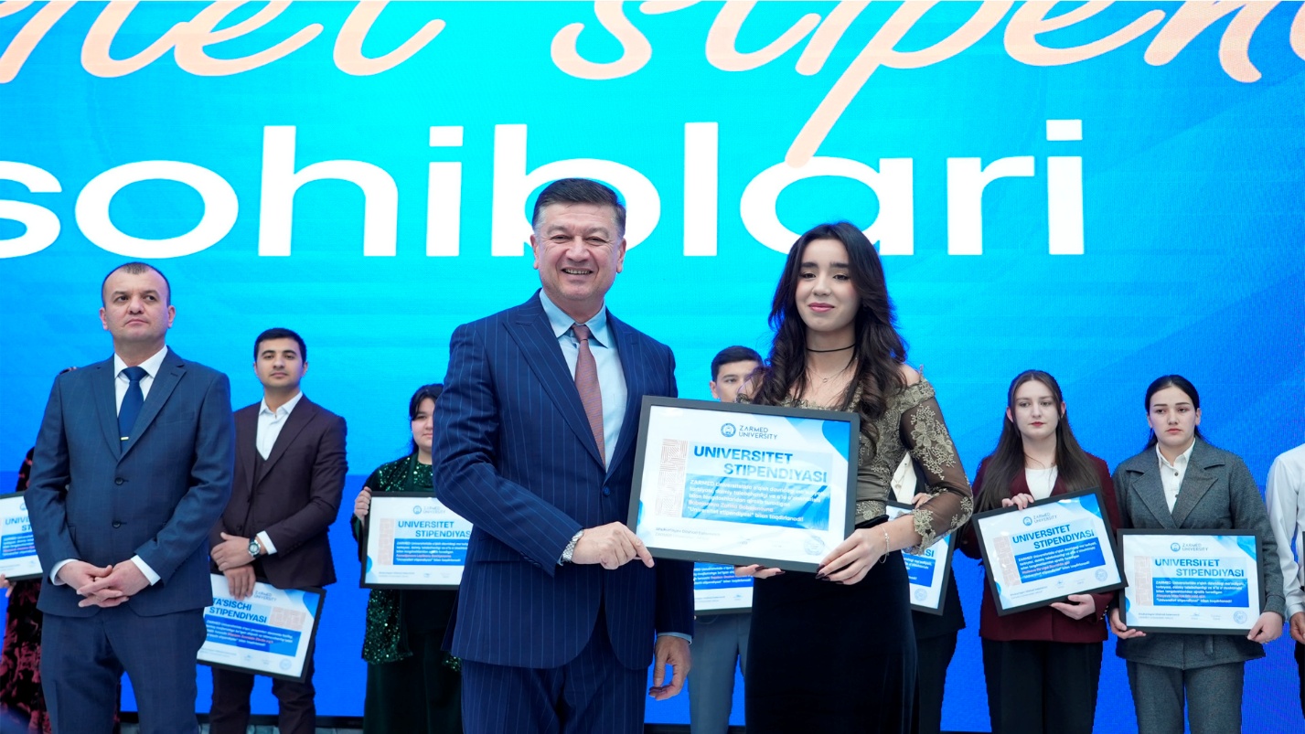 Student receiving scholarship award on stage